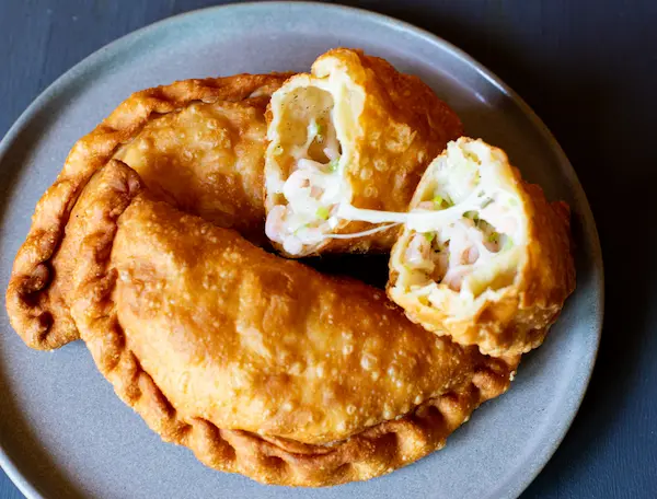 Man in kitchen preparing caribbean food